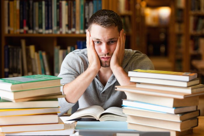 Depressed student having a lot to read